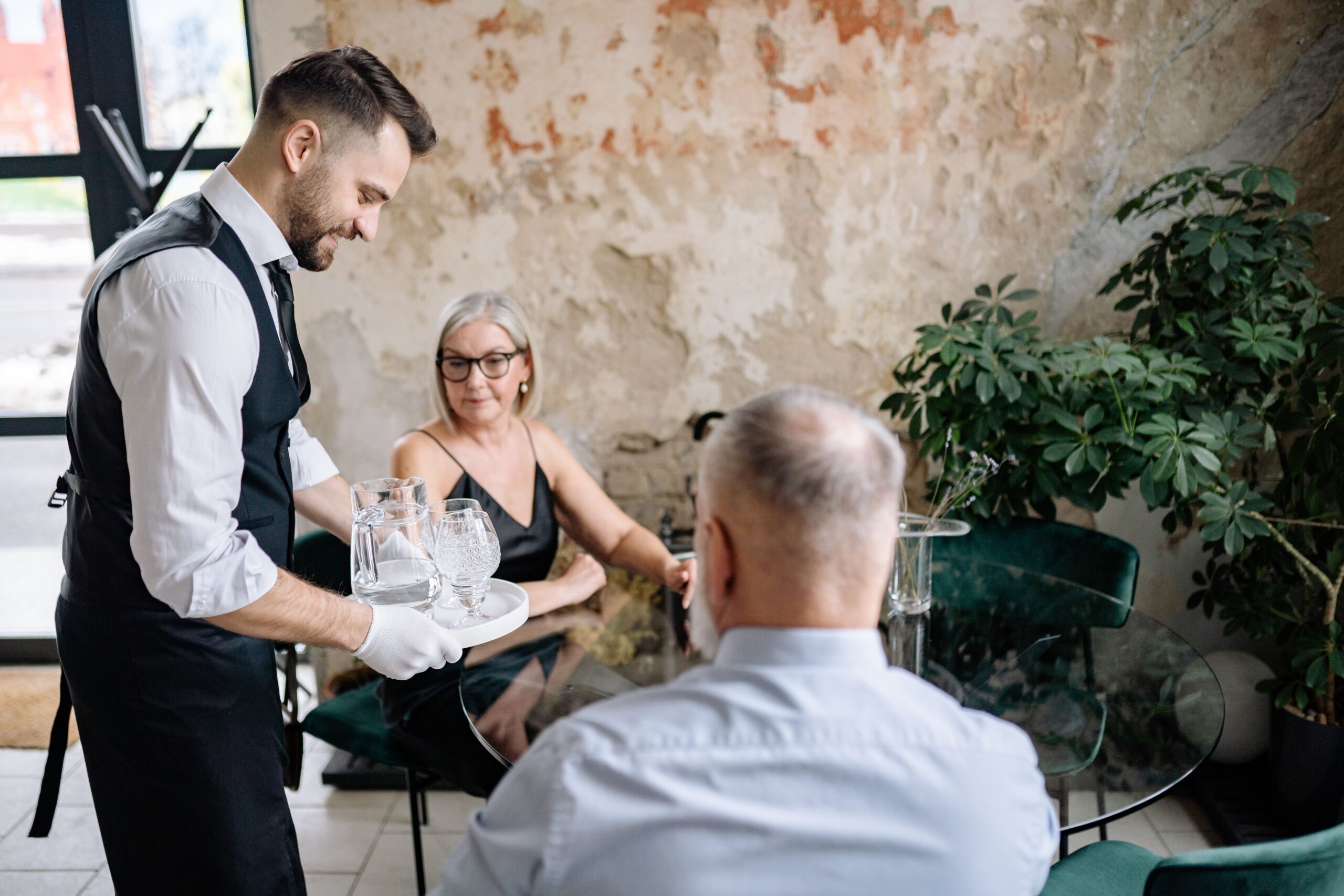 Banquet servers setting tables at an event